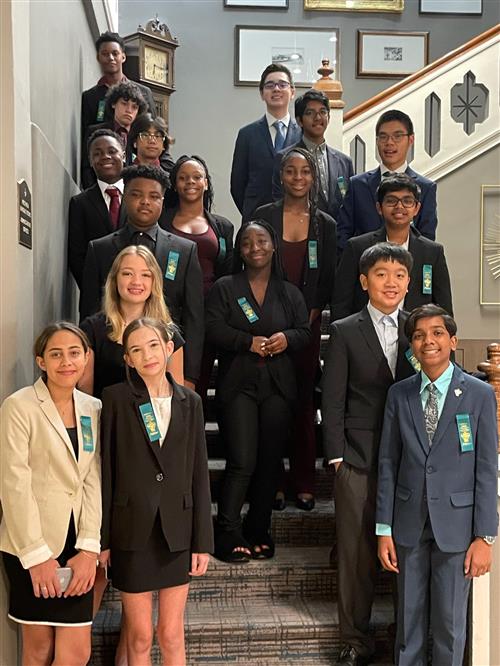 debate students dressed up and standing on stairs
